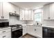 A beautifully updated kitchen featuring white cabinets, subway tile backsplash, and stainless steel appliances at 4926 Crittenden Ave, Indianapolis, IN 46205