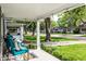 Inviting covered porch with seating and a view of the neighborhood and mature trees at 4926 Crittenden Ave, Indianapolis, IN 46205