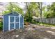 Backyard shed in a fenced yard, offering additional storage space and a patio area with a bench at 4926 Crittenden Ave, Indianapolis, IN 46205