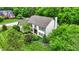 Aerial view of a beautiful house with lush green landscaping and mature trees surrounding the property at 5268 Woodfield Dr N, Carmel, IN 46033