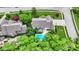 Backyard aerial view of a home, showcasing a sparkling blue pool, mature trees, and manicured lawns at 5268 Woodfield Dr N, Carmel, IN 46033