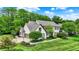Stunning aerial view of a home showcasing its well-kept lawn and mature trees and nice-looking roof at 5268 Woodfield Dr N, Carmel, IN 46033