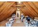 Spacious unfinished attic space with wood beams providing ample storage and potential for customization at 5268 Woodfield Dr N, Carmel, IN 46033