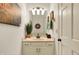 Elegant bathroom with a cream vanity, updated lighting, and artwork at 5268 Woodfield Dr N, Carmel, IN 46033