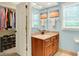 Well-lit bathroom features a granite countertop, modern sink, and open closet for ample storage space at 5268 Woodfield Dr N, Carmel, IN 46033