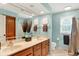 Bathroom featuring a double sink vanity, a large mirror, and a shower with a curtain at 5268 Woodfield Dr N, Carmel, IN 46033