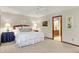 Bright bedroom with plush carpet, a ceiling fan, and a comfortable bed overlooking a view of the en suite bathroom at 5268 Woodfield Dr N, Carmel, IN 46033