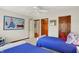 Bright bedroom featuring two twin beds with blue comforters and charming decor at 5268 Woodfield Dr N, Carmel, IN 46033