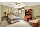 Comfortable bedroom featuring a ceiling fan, window, and furnished with wicker furniture and decor at 5268 Woodfield Dr N, Carmel, IN 46033