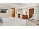 Inviting bedroom with carpet, rocking chair, ceiling fan, wood trim, and a comfortable bed at 5268 Woodfield Dr N, Carmel, IN 46033