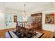 Elegant dining area with wood floors, wainscoting, and large china cabinet at 5268 Woodfield Dr N, Carmel, IN 46033