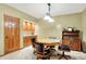 Inviting dining area with a wooden table, chairs, built-in cabinets and a charming light fixture at 5268 Woodfield Dr N, Carmel, IN 46033