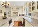 This beautiful kitchen has an island with granite countertops, stainless steel appliances, and custom cabinetry at 5268 Woodfield Dr N, Carmel, IN 46033