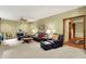 Cozy living room with comfortable seating, natural lighting, and an open doorway to another room at 5268 Woodfield Dr N, Carmel, IN 46033