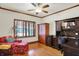 Comfortable living room with hardwood floors and dark wood built-in desk and cabinetry at 5268 Woodfield Dr N, Carmel, IN 46033