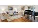 Cozy living room with hardwood floors, piano, comfortable seating, and elegant decor at 5268 Woodfield Dr N, Carmel, IN 46033