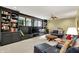 Expansive living room with built-in shelving, entertainment center, and comfortable black leather seating at 5268 Woodfield Dr N, Carmel, IN 46033