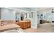 Elegant bathroom featuring a large soaking tub, tiled countertop, and access to the main bedroom at 5268 Woodfield Dr N, Carmel, IN 46033