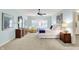 Bright main bedroom with large windows, ceiling fan, and an en-suite bathroom at 5268 Woodfield Dr N, Carmel, IN 46033