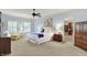 Spacious main bedroom with a ceiling fan, sitting area, and an en-suite bathroom with a walk-in closet at 5268 Woodfield Dr N, Carmel, IN 46033