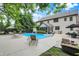 This backyard features a beautiful pool, umbrella, dining area, and lounge chairs, perfect for relaxing and entertaining at 5268 Woodfield Dr N, Carmel, IN 46033