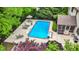 Aerial view of a refreshing pool surrounded by lounge chairs and lush trees creating a serene outdoor oasis at 5268 Woodfield Dr N, Carmel, IN 46033