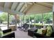 Comfortable screened-in porch with outdoor seating, dining set, and backyard view at 5268 Woodfield Dr N, Carmel, IN 46033