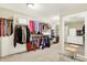Large walk-in closet features carpet, organized shelving, hanging racks, and plenty of storage at 5268 Woodfield Dr N, Carmel, IN 46033