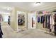 Spacious walk-in closet featuring organized shelving, mirrors, and carpet at 5268 Woodfield Dr N, Carmel, IN 46033