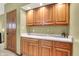 Well-lit wet bar with wooden cabinets and ample counter space, perfect for entertaining guests at 5268 Woodfield Dr N, Carmel, IN 46033