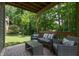 Covered back patio includes outdoor seating with beautiful backyard views and lush surroundings at 527 Macintosh Ln, Danville, IN 46122