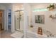 Well-lit bathroom with a soaking tub, glass-enclosed shower, and decorative shelves at 527 Macintosh Ln, Danville, IN 46122