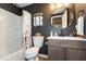 Stylish bathroom with dark accent wall, framed round mirror, modern vanity, and shower-tub combination at 527 Macintosh Ln, Danville, IN 46122