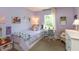 Bright bedroom features lavender walls, single bed, desk, ample sunlight and comfortable furnishings at 527 Macintosh Ln, Danville, IN 46122
