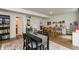 Open dining area featuring a large dining table and chairs next to a foosball table, bookcase, and white walls at 527 Macintosh Ln, Danville, IN 46122