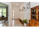 Inviting entryway featuring wainscoting, coat hooks, bench, and a view into a room with large windows at 527 Macintosh Ln, Danville, IN 46122