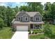 Beautiful two-story home boasts manicured lawn, front porch sitting area, and attached two-car garage at 527 Macintosh Ln, Danville, IN 46122
