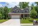 Front view of a beautifully landscaped two-story home with a brick and siding exterior, plus an attached two-car garage at 527 Macintosh Ln, Danville, IN 46122