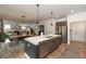 Open kitchen area showcasing the large island with sink and seating, and a dining area beyond at 527 Macintosh Ln, Danville, IN 46122