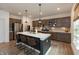 Well-lit kitchen featuring a large island with barstool seating, stainless steel appliances, and plentiful cabinets at 527 Macintosh Ln, Danville, IN 46122