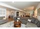 Spacious open concept living room with stylish gray sectional, area rug, and lots of natural light at 527 Macintosh Ln, Danville, IN 46122