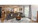 Open concept living room featuring a sectional sofa, area rug, foosball table, and natural light at 527 Macintosh Ln, Danville, IN 46122