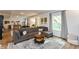 Open-concept living room with a large sectional sofa, area rug, and view of the stairs to the outdoors at 527 Macintosh Ln, Danville, IN 46122