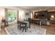 Inviting space with dining table, living area with sectional, and access to a deck, creating indoor-outdoor flow at 527 Macintosh Ln, Danville, IN 46122
