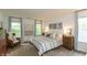Serene main bedroom with large windows, comfortable bedding, and tasteful decor at 527 Macintosh Ln, Danville, IN 46122