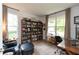 Home office with built-in bookshelves, a comfortable chair, and a large window for natural light at 527 Macintosh Ln, Danville, IN 46122