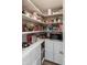 Walk-in pantry features white shelving and cabinets for optimal storage and organization of food items at 527 Macintosh Ln, Danville, IN 46122