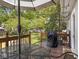 Inviting back deck with an umbrella-covered table, chairs, and view of backyard with grill at 5342 Central Ave, Indianapolis, IN 46220