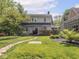 Well-maintained backyard featuring a stone pathway, a deck, and manicured landscaping at 5342 Central Ave, Indianapolis, IN 46220