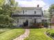 Backyard with stone path leading to a deck, lush green lawn, and mature trees at 5342 Central Ave, Indianapolis, IN 46220